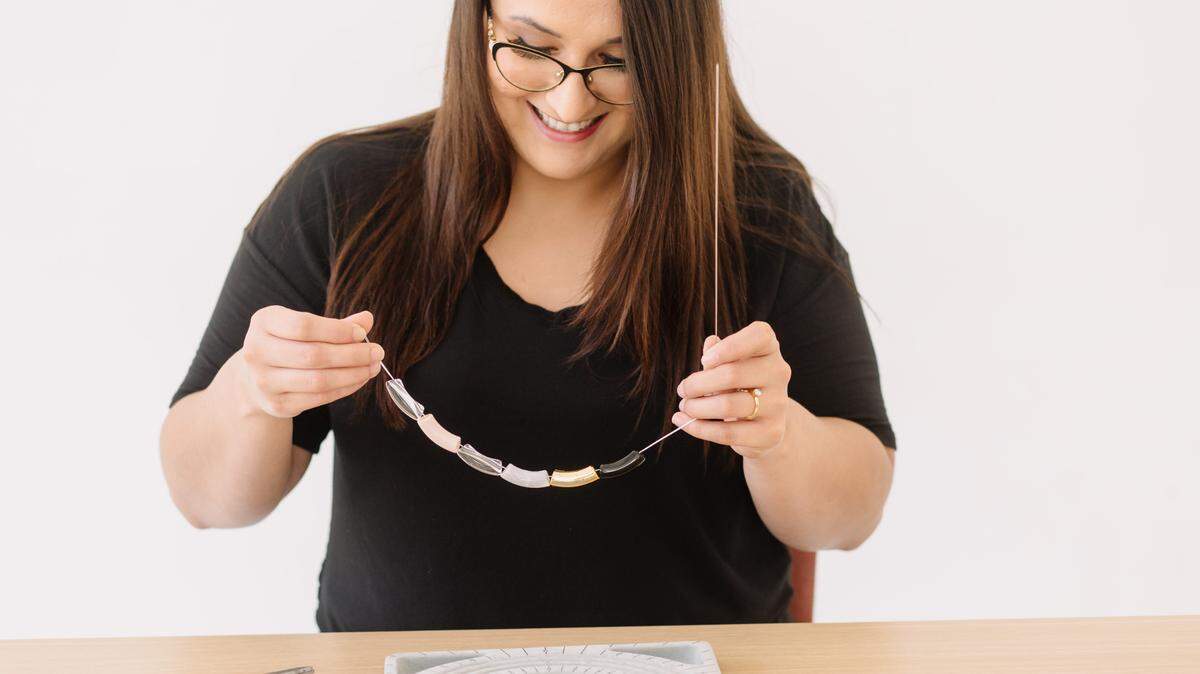 Gabrielle Meija, 28, is an artisan jewelry maker at The Worthy Co in Fort Worth. The social enterprise employs women who are survivors of sex trafficking or exploitation and teaches them life skills. Meija and other survivors create jewelry that is sold at the company’s retail location.
