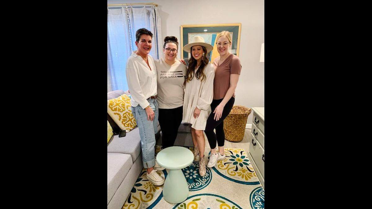 The Net recently partnered with Dwell with Dignity to provide interior design services to survivors of sexual exploitation and trafficking. Debby Pond (an advocate at The Net), Gabrielle Meija, Melissa Ice (founder and executive director at The Net) and Angela Wall (The Net economic empowerment case manager) stand inside Meija’s newly designed home.