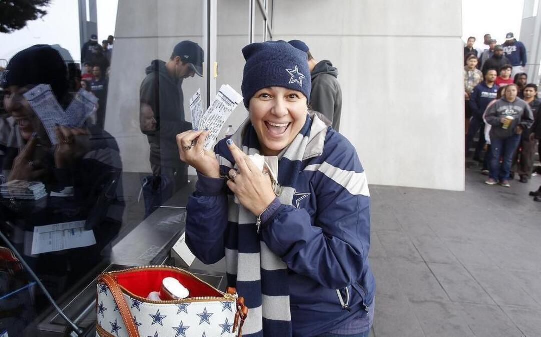 Maria Espinosa of Grand Prairie shows off her Dallas Cowboys playoff tickets at AT&T Stadium in Arlington.