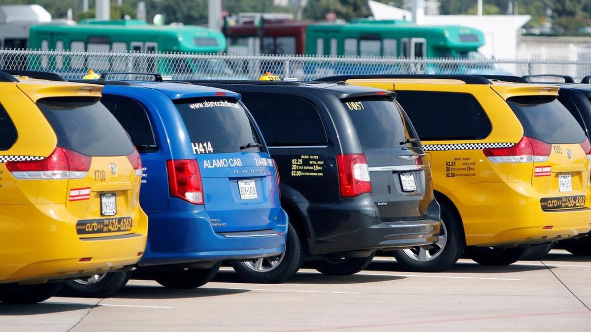Cab drivers wait at the taxi queue facility at DFW Airport to be dispatched to the terminals, Tuesday, August 4, 2015. Uber, Lyft and other smartphone-based car services are now allowed to pick up passengers at DFW Airport. Fort Worth is looking to rewrite its ordinance.
