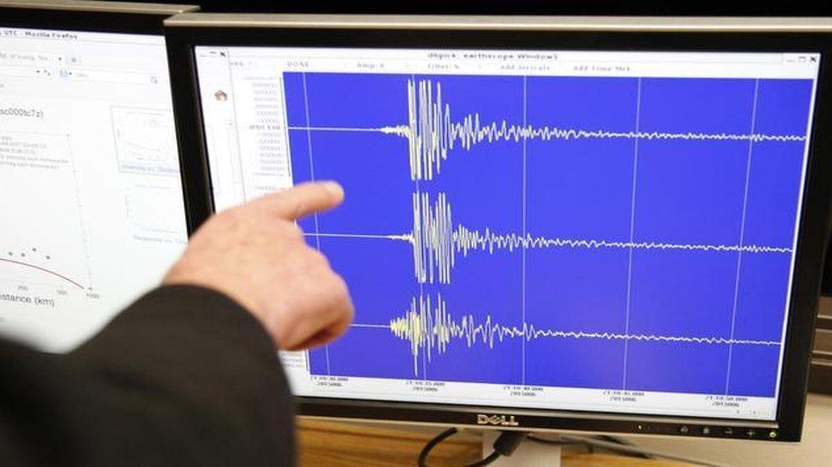 
Brian Stump, professor of earth sciences at SMU, points to seismographs at a news conference in January about earthquakes in North Texas. 
