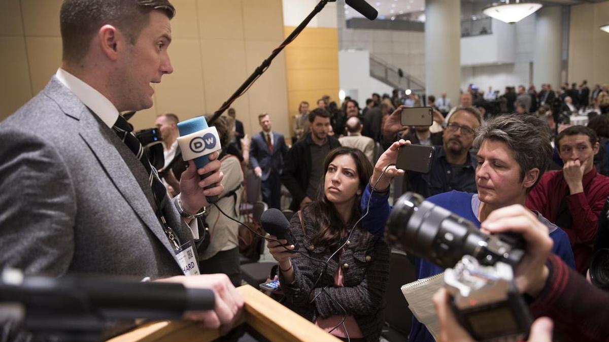 Richard Spencer, left, talks to the media Nov. 18 at an alt-right conference hosted by the National Policy Institute in Washington.