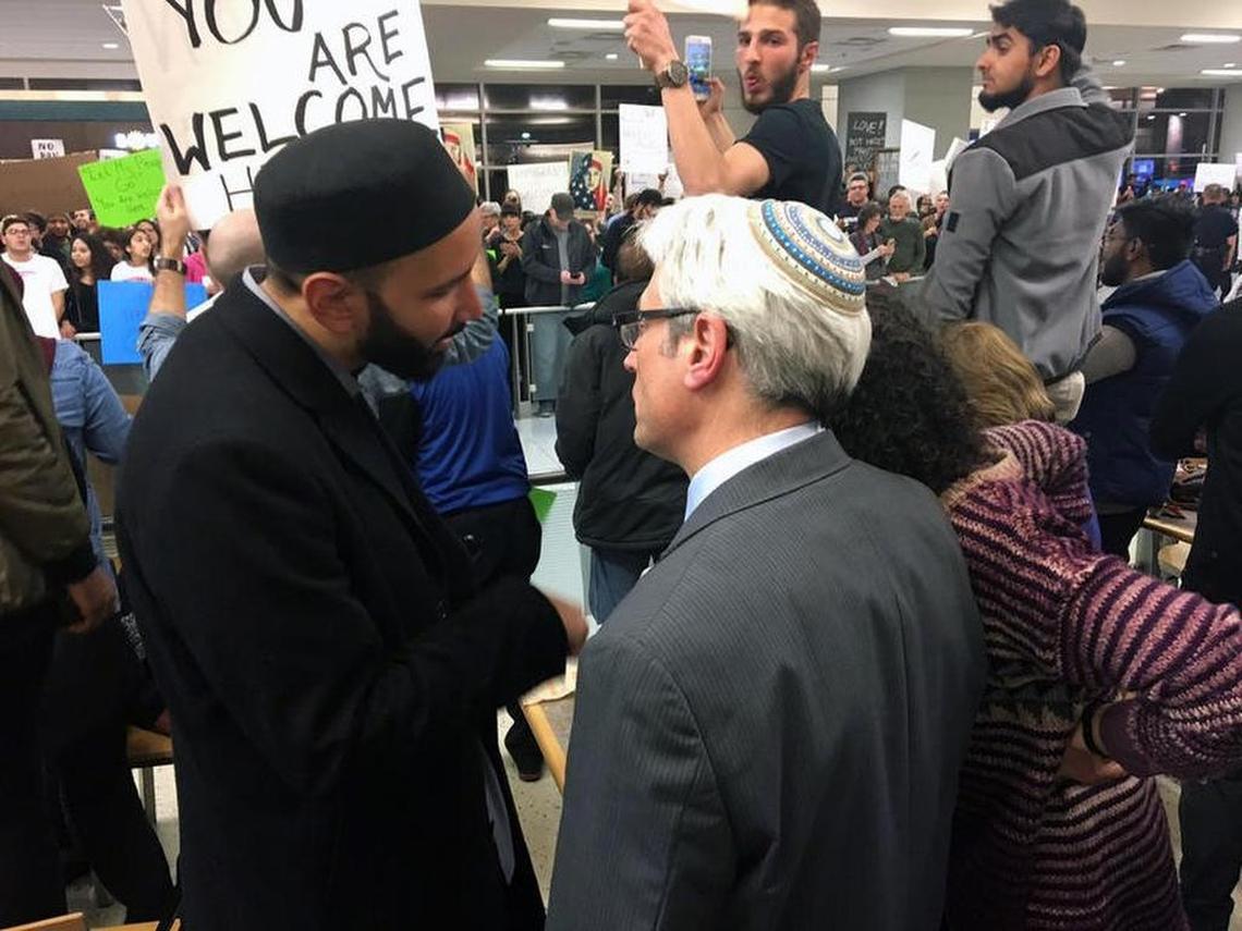Imam Omar Suleiman (left) and Rabbi David Stern (right) talk while protesting President Trump's executive order banning travelers from seven Muslim-majority countries, at D/FW International Airport on Jan. 28.