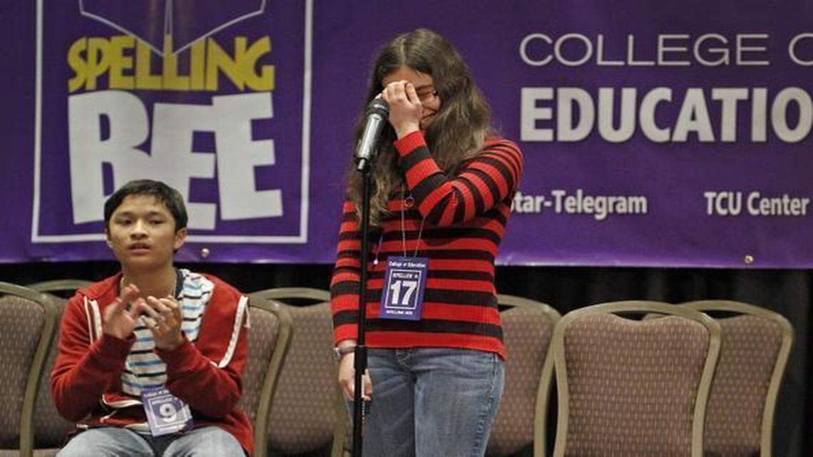 
Bee champion Michelle Yakubek reacts after spelling noblesse to defeat runner-up Benjamin Benjadol, left, at the regional spelling bee Wednesday at TCU.
