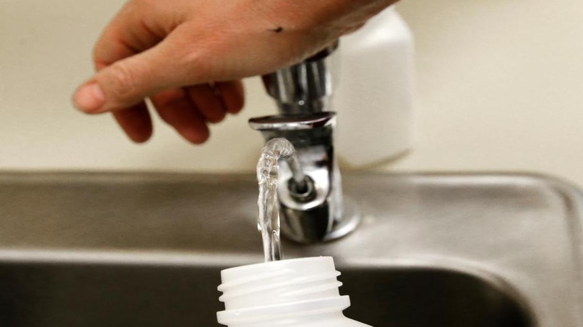 A water sample is taken from a drinking fountain in an elementary school in Washington. Fort Worth has found elevated levels of lead in some of its fountains this summer and is replacing them.