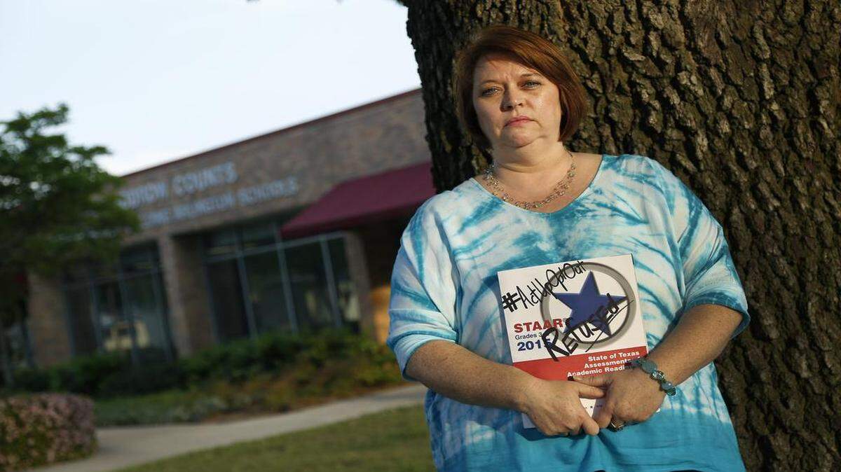 
Arlington teacher Kimberly Martinez is shown outside the school district administration building Thursday where trustees approved a resolution urging the Texas Legislature to end high-stakes tests and allow local school boards to use their own accountability systems. Martinez is withholding her son from taking the STAAR next week to protest standardized testing. 
