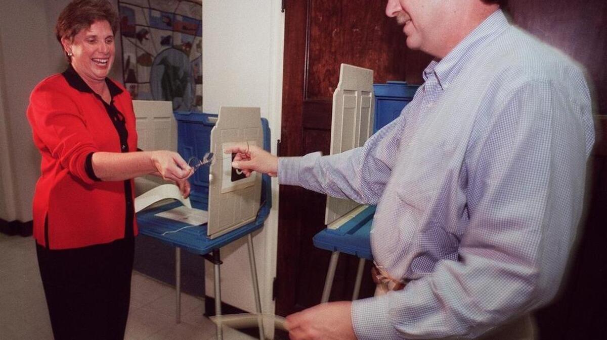 
Cathy and Darrell Hirt shared a laugh casting votes in 2003, the first year she ran for Fort Worth mayor. To their amusement, Hirt had to borrow her husband's reading glasses to read the ballot. 
