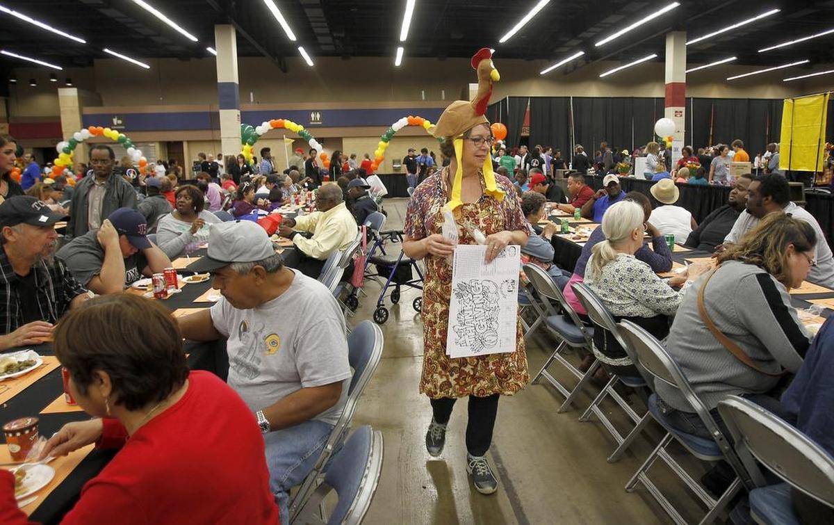 Volunteer Rita Lindbom of North Richland Hills help set meals up for guests at the H-E-B/Central Market Feast of Sharing at Will Rogers Memorial Center in Fort Worth on Tuesday, Nov. 10, 2015.