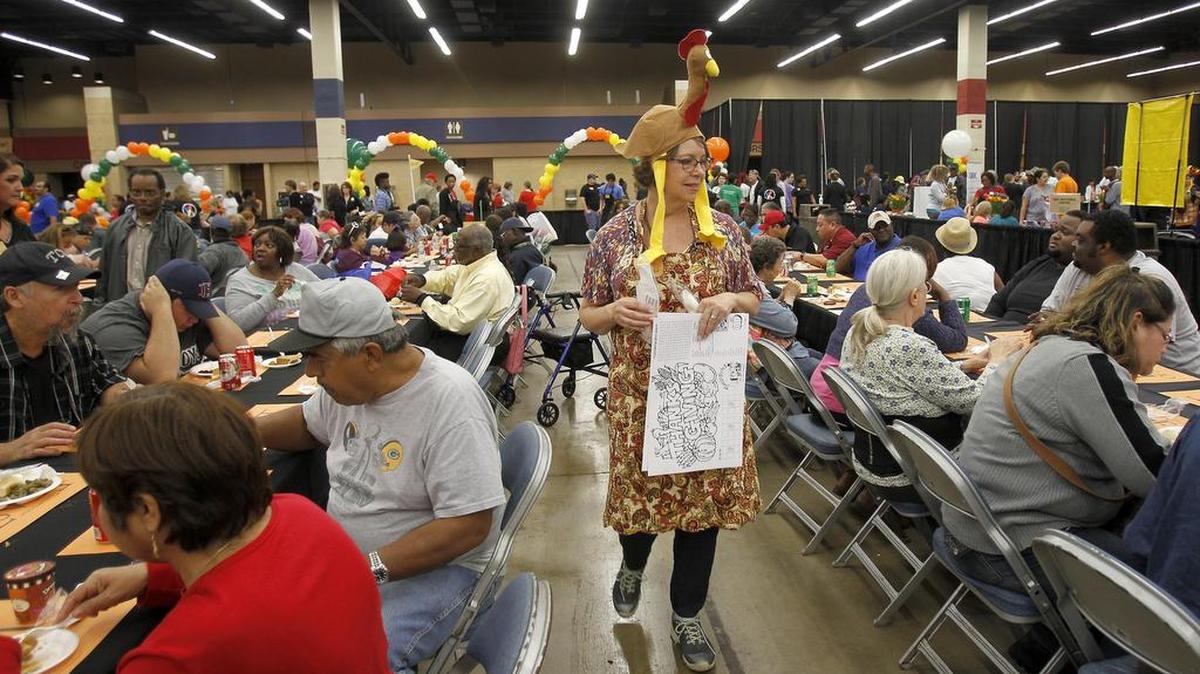 Volunteer Rita Lindbom of North Richland Hills help set meals up for guests at the H-E-B/Central Market Feast of Sharing at Will Rogers Memorial Center in Fort Worth on Tuesday, Nov. 10, 2015.