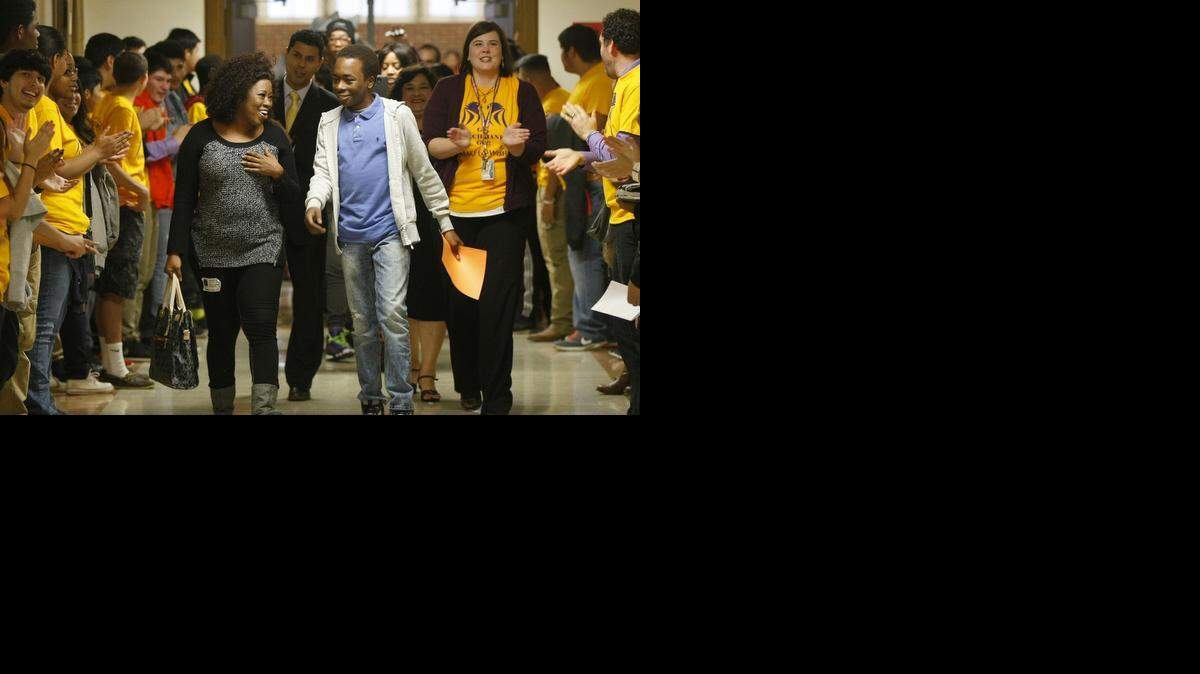 
Polytechnic High School sophomore Banks Graham and his mother, Edna Graham, left, are greeted with applause at the school in Fort Worth on Wednesday, Dec. 17, 2014. The Make-a-Wish Foundation granted Banks Graham his wish of coaching a Los Angeles Lakers game.
