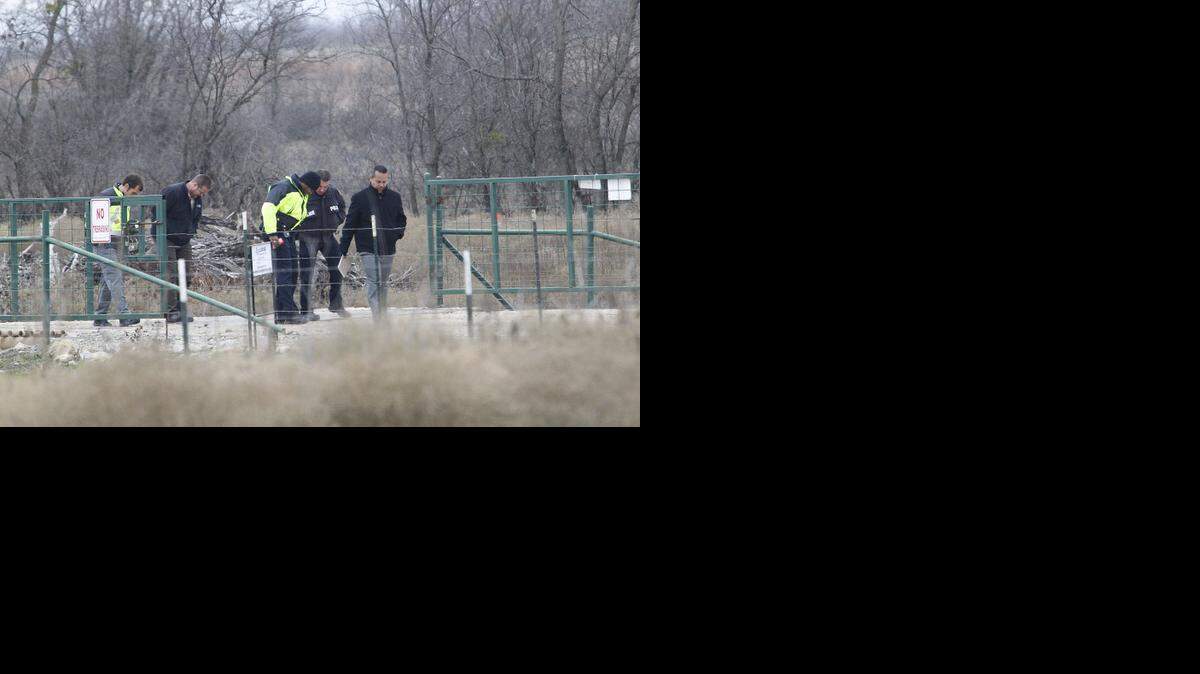 
Fort Worth police search the area near where the bodies of a woman and young child were found in a field south of Dirks Road near Bryant Irvin Tuesday. Circumstances of the deaths are under investigation. 
