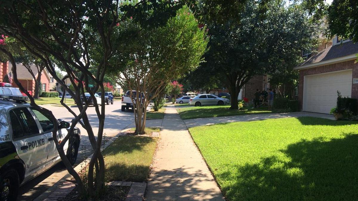 
Residents gather in front of a home in the 5200 block of Glen Spring Trail in north Fort Worth while police investigate the apparent drowning death of a man in the swimming pool in the back yard Saturday morning.
