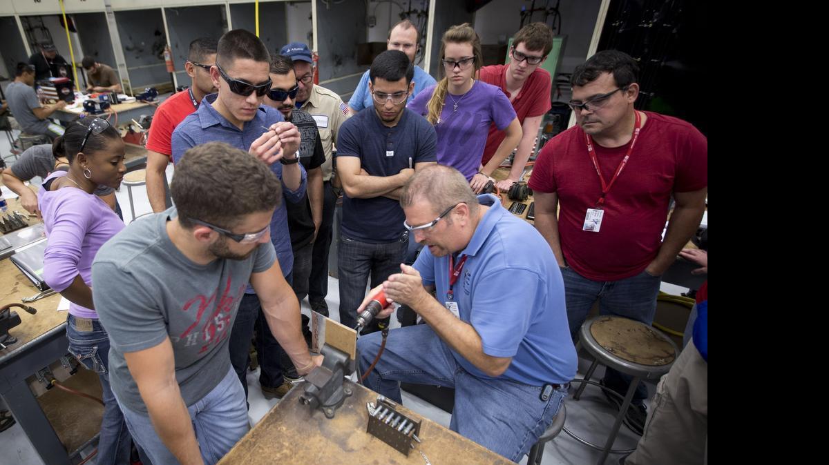 
Instructor Mark Loud teaches student how to rivet in the sheet metal class at Tarrant County College's Aviation Maintenance Technology Program in the Center of Excellence for Aviation, Transportation and Logistics.
