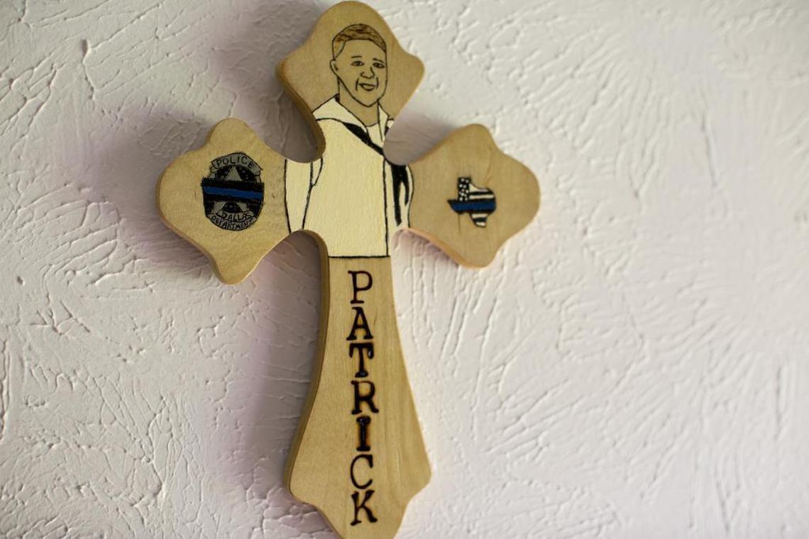 A cross hangs on the wall of Valerie Zamarripa's home in honor of her son Patrick, a Navy veteran and former Dallas police officer who was killed in the Dallas Police shooting of 2016.