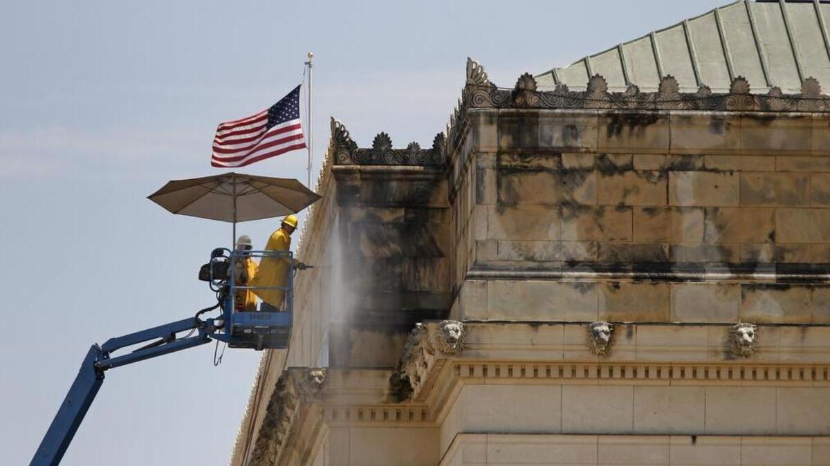 
Crews use low-pressure washers to remove years of dirt from the limestone exterior of the post office building on Lancaster Avenue. After all the stone is cleaned, it will be sealed to help protect it and preserve the clean look.
