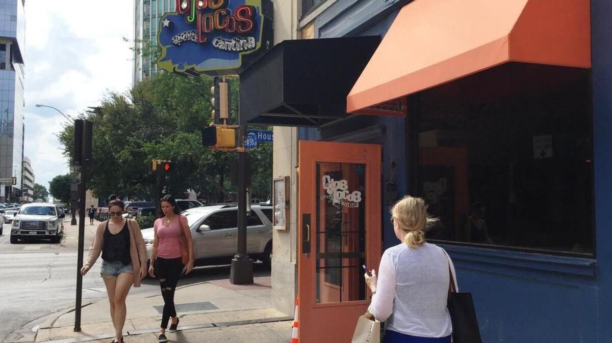 Pedestrians walk past the closed Ojos Locos sports bar and restaurant at 515 Houston St. Tuesday (Sept. 26, 2017) in downtown Fort Worth. A two-story CVS Pharmacy is scheduled to open at that location by early next year.