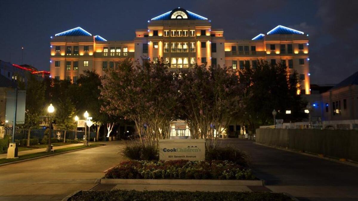
Cook Children's Hospital is lit with gold lights to kick off Childhood Cancer Awareness Month on Tuesday, Sept.1, 2015.
