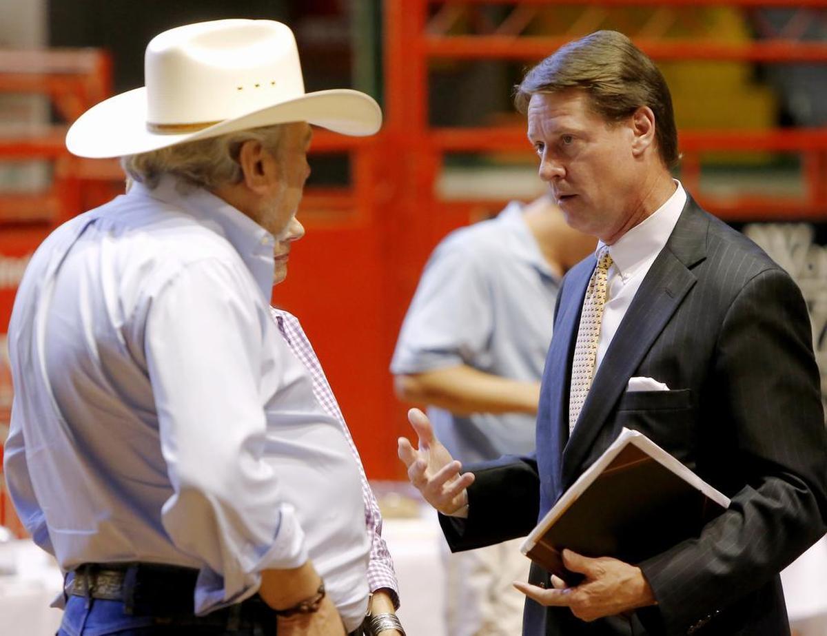Brad Hickman, right, of Hickman Companies attends a presentation showcasing the possibilities of revitalizing the Stockyards in 2015.