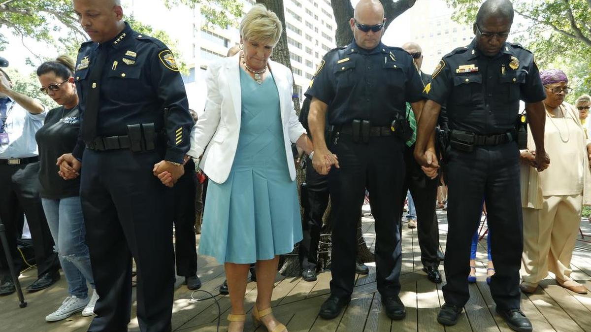 Fort Worth police Chief Joel Fitzgerald, left, Mayor Betsy Price, Rick Van Houghton of the Fort Worth Police Officers Association and Roy Hudson of the Fort Worth Black Law Enforcement Association join a prayer service for the five Dallas police officers killed July 7, 2016. The Fort Worth event was in Burnett Park on Friday July 8, 2016.