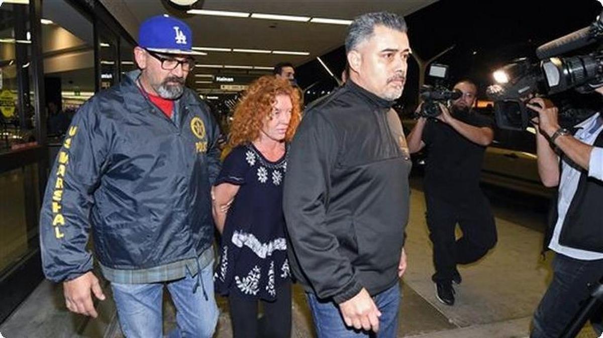Tonya Couch, center, is taken by authorities to a waiting car after arriving at Los Angeles International Airport, Dec. 31, 2015, in Los Angeles.