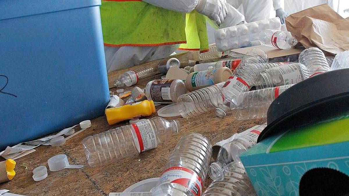 A city employee sorts through a recycling bin in 2014.