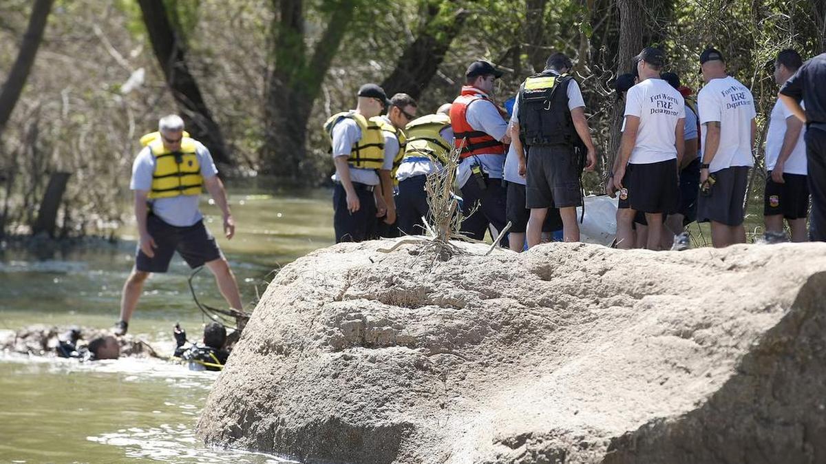 Firefighters work the scene of a drowning at West Fork Trinity River near the Lake Worth dam in Fort Worth on Wednesday, May 4, 2016.