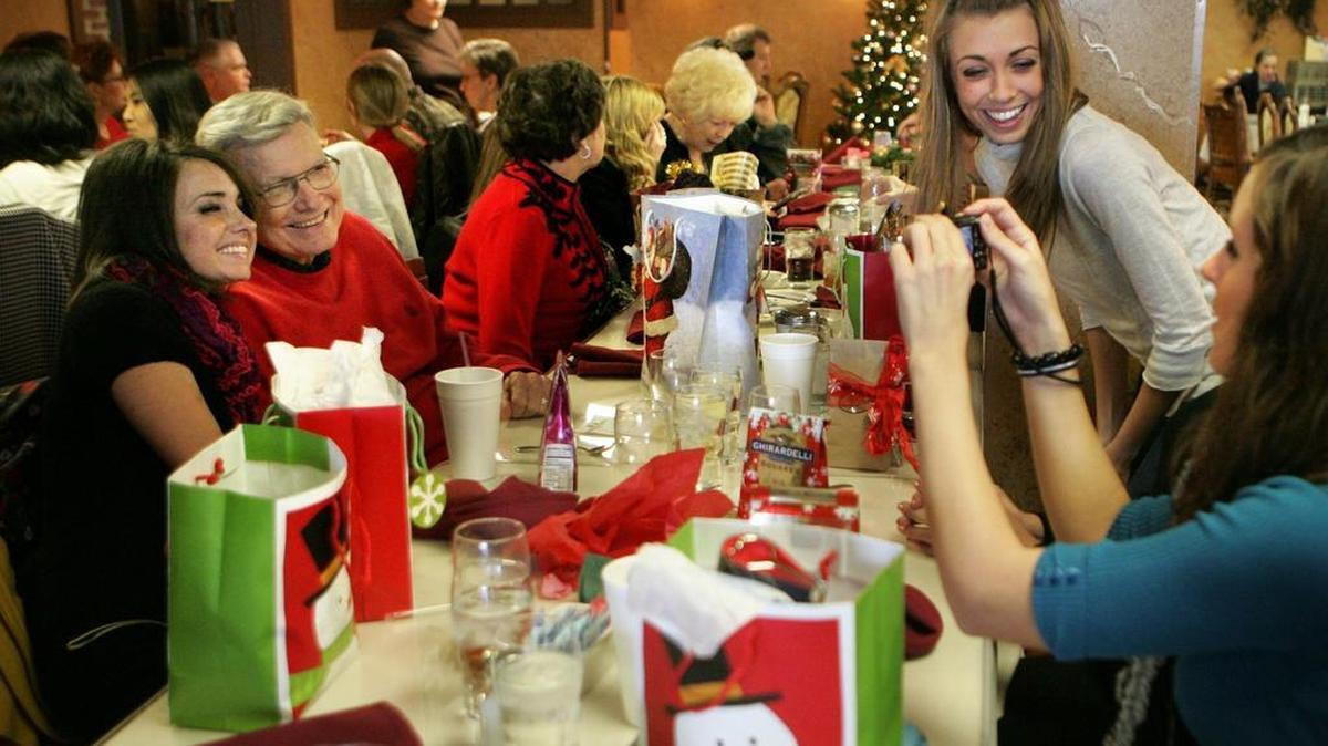 
Katie Vinson, of Fort Worth, has her photo taken with her "PawPaw" Dan Wall of Bedford, patriarch of the extended "Wall, party of 15" family gathered at Vance Godbey's restaurant on Sunday, Dec. 21, 2008. Taking their picture is granddaughter Kendra Wall, bottom right, with granddaughter Tracy Drake, second from right. The restaurant is closing for good Oct. 11.

