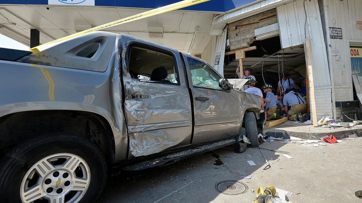 A woman was killed after this pickup crashed into the Star Food Mart in Fort Worth.