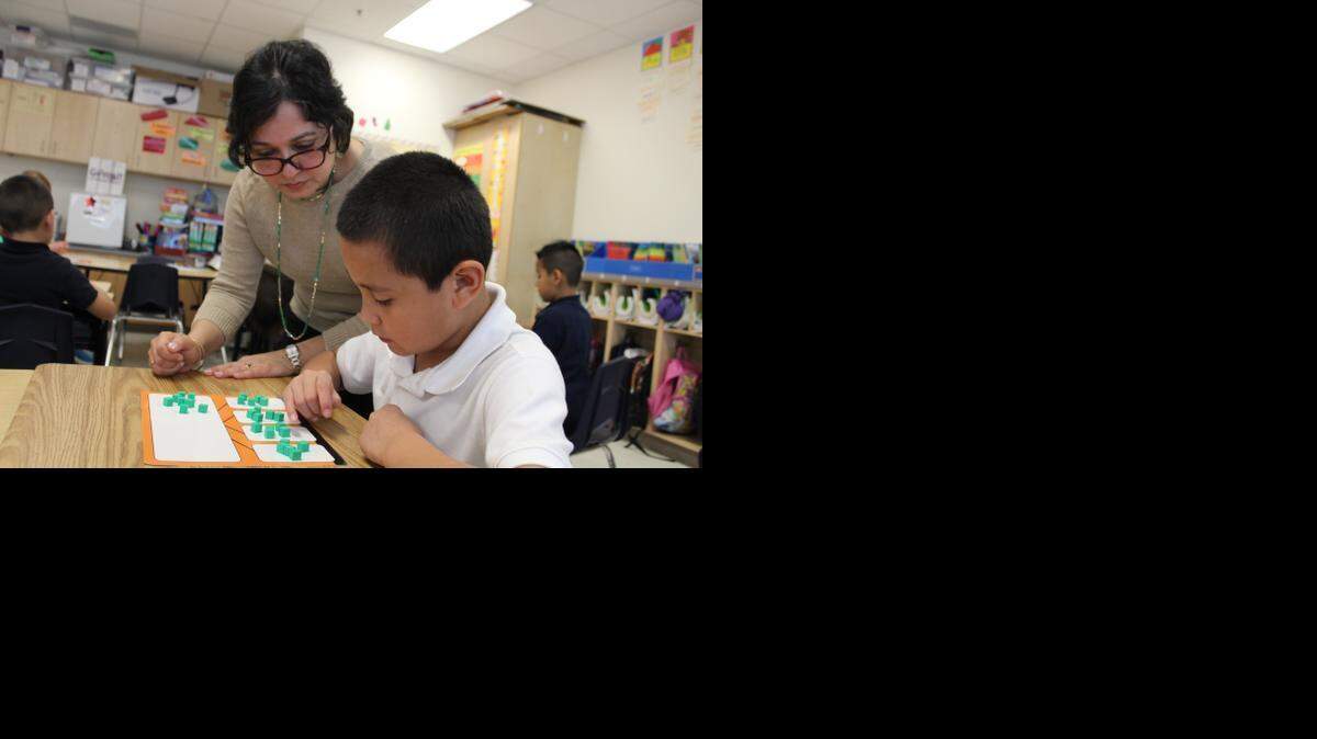 
Ritu Balial, a principal intern at Rosemont Elementary School in Fort Worth, works on math exercises with second-grader Benjamin Garcia, 8.
