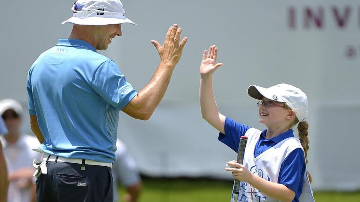 First Tee of Fort Worth caddie Samantha Gibbs gets a high five from pro golfer Ben Crane after Crane let her putt on 13 during the Colonial Pro-Am during the 2015 PGA event at Colonial Country Club.