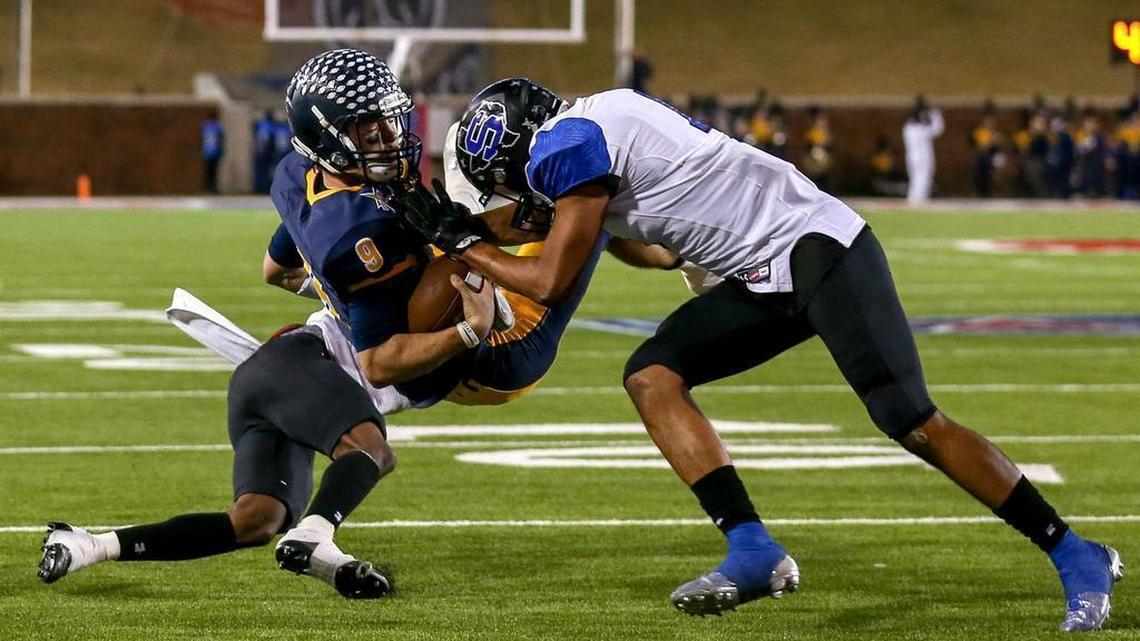 Highland Park quarterback John Stephen Jones is hit hard by Mansfield Summit defensive back Corey Washington (4) during a playoff game at SMU’s Ford Stadium in Dallas.