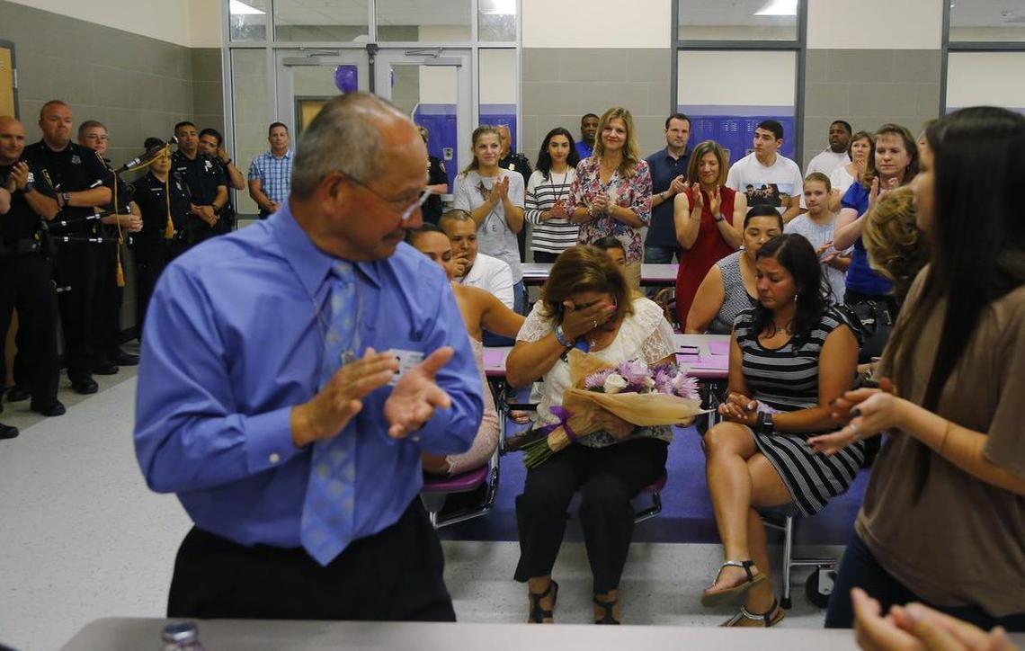 Valerie Zamarripa cries after being given flowers as Paschal High School awards 12 scholarships of $1,000 each to students in honor of her son, Dallas police officer Patrick Zamarripa, a Paschal graduate.