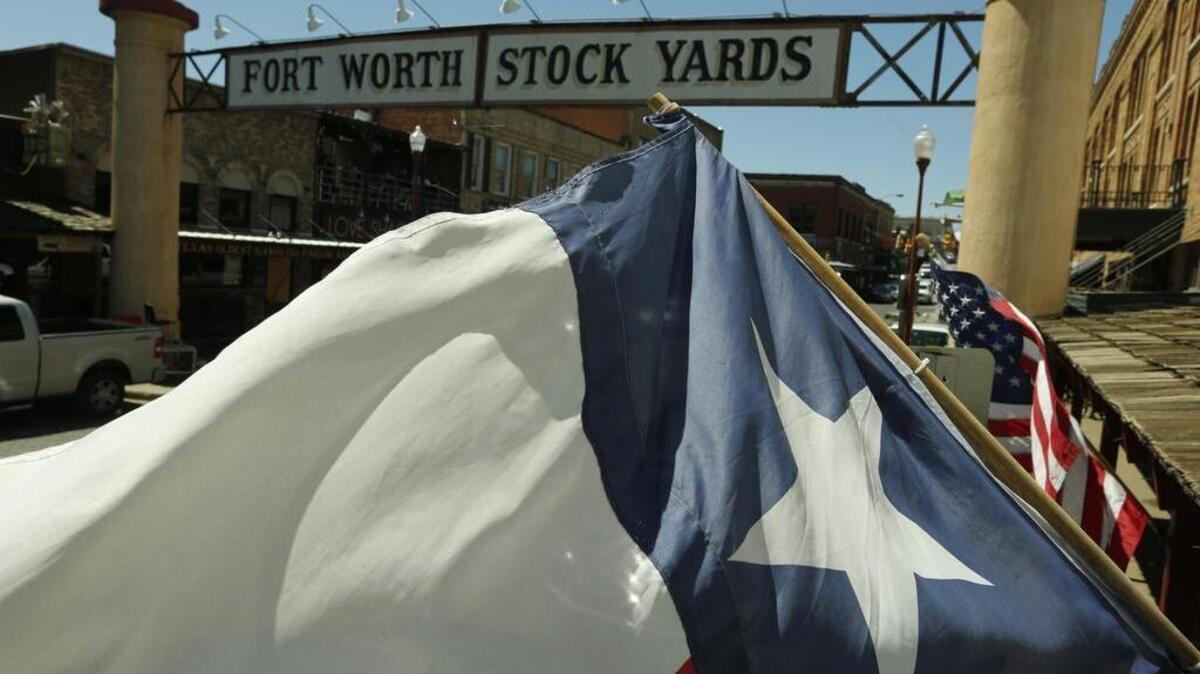 Live: Flags fly along Exchange Ave. in the Fort Worth Stockyards Wednesday March 6, 2016. The city council has approved a smaller historic district for the area. (Special to the Star-Telegram/Ron T. Ennis)