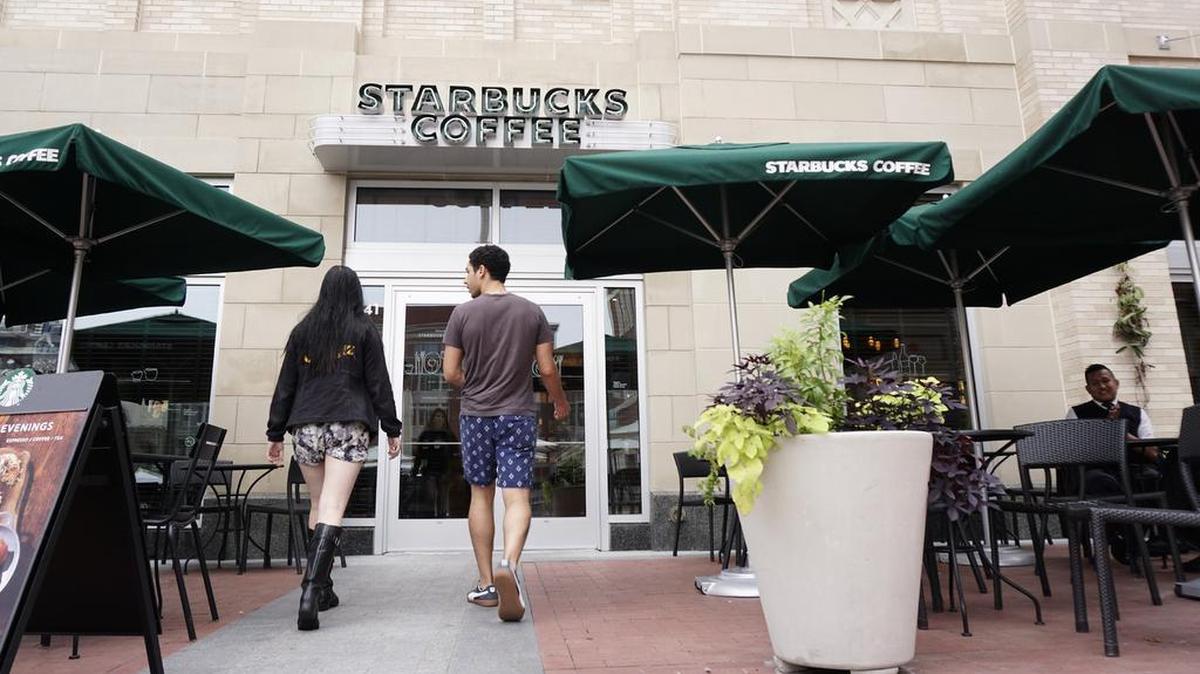 Patrons enter the Sundance Square Starbucks Tuesday. The company announced a new evening menu and added beer and wine to its drink selections.