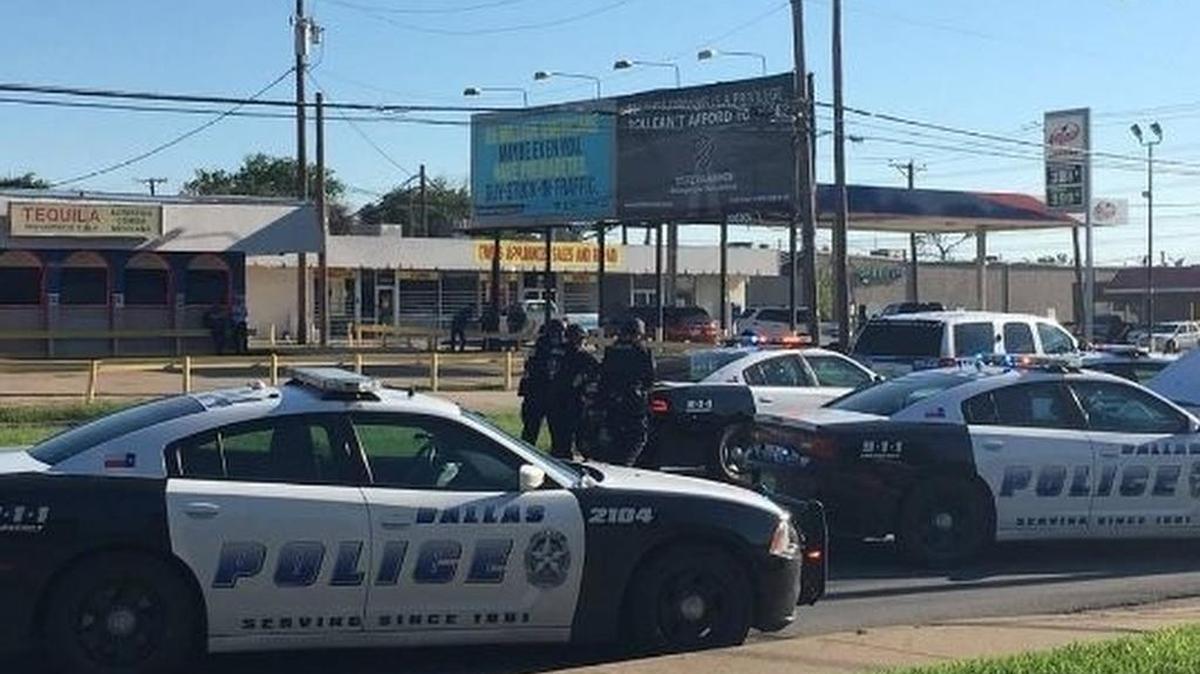 Officers surround the Walnut Inn Tuesday where a murder suspected barricaded himself for almost three hours.
