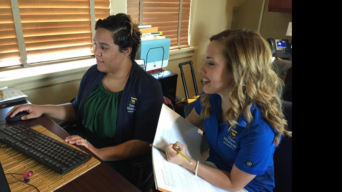 
Melondy Doddy left, Texas Wesleyan admissions counselor and community outreach coordinator, reviews a monthly report with mentor and junior education major Nicole Gillihan. Gillihan is going to help people find out more about applying for colleges this summer at a Go Center at the Fort Worth Central Library in downtown Fort Worth.
