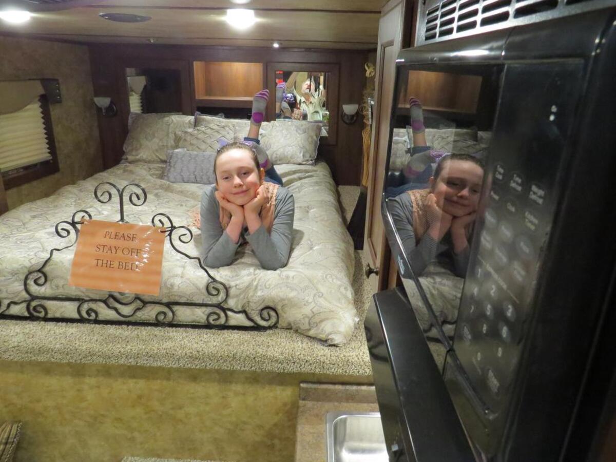 Kendalyn Lopez, 10, of Fort Worth, tries out the bed in a stock/living quarter trailer at the Fort Worth Stock Show.