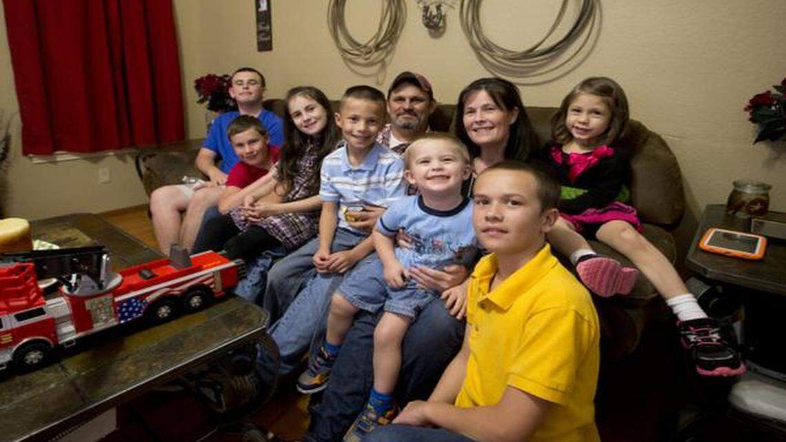
The Cook family, from left, Justin, 14; Bryan, 12; Paige, 9; David Jr., 8; David Sr., the father; Wesley, 2, Angel, the mother; Austin, 13; and Mary Jane, 4. The family was pulled apart when David and Angel were accused of killing their adopted son Buddy. They were cleared of charges and the children were returned, but the Cooks say some of the children were abused in foster care. They are trying to put their lives back together.

