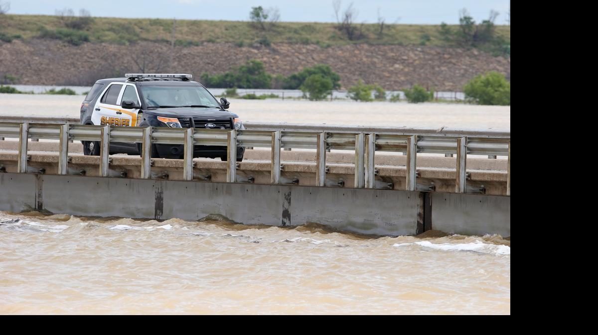 
A sheriff's vehicle on U.S. 380 going over Lake Bridgeport on Saturday, the lake level hitting the bottom of the bridge as areas flood around Bridgeport.
