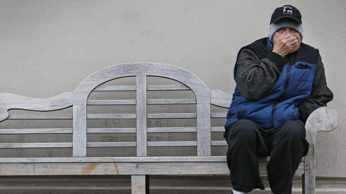Marciano Rodriguez tries to stay warm while waiting at a downtown bus stop Thursday afternoon, as temperatures plummeted during the day, Jan. 11, 2018.