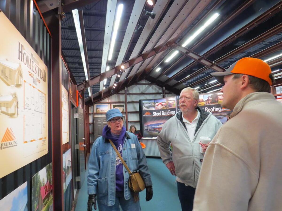 Carol and Preston Lawless of Joshua hear a pitch about a metal building from Bud Matus of Mueller Inc.