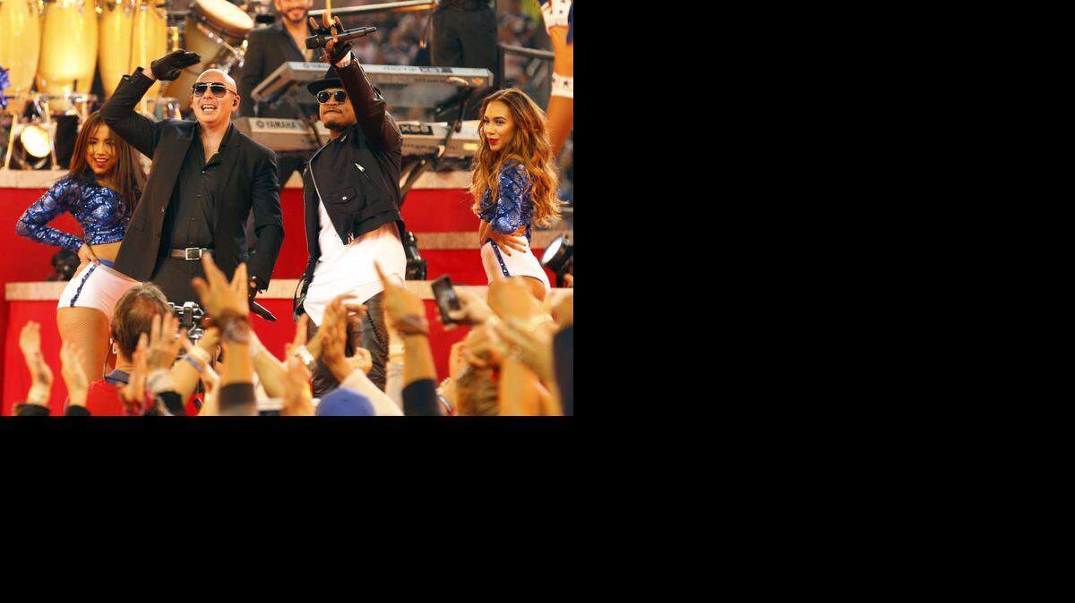 
Pitbull and Ne-Yo perform during halftime show at the Thanksgiving game between the Philadelphia Eagles and the Dallas Cowboys at AT&T Stadium Nov. 27. 
