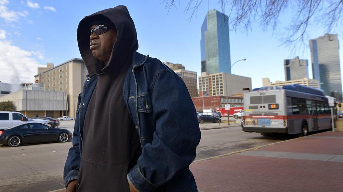 Alfred Smoot waits for a bus in the 18 degree weather at Intermodal Transportation Center in Fort Worth, Tuesday.