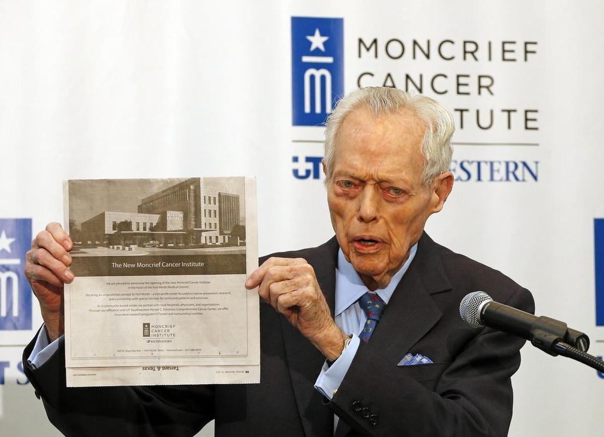 Tex Moncrief holds up a photo of the new Moncrief Cancer Institute during a ceremony for it’s grand opening on November 19, 2012.
