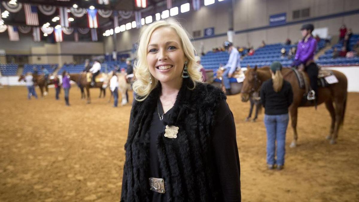 Lauren Lovelace, horse show manager at Fort Worth Stock Show and Rodeo, hands out awards at the Chisholm Challenge for Special Riders on Monday.