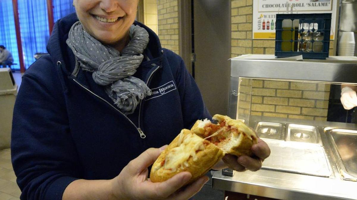 Monica Russo, owner of Momma Monica Italian Restaurant, holds a veggie Parmigiana sub. Her food booth is new this year at the Stock Show.