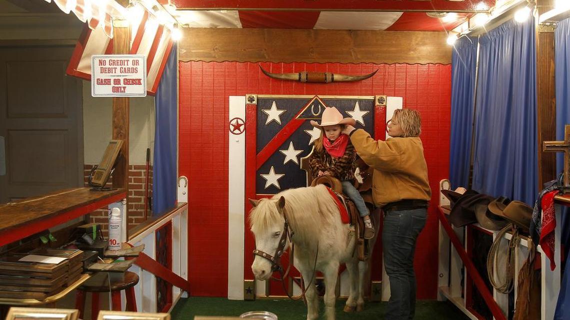Photographer Sarah Rinehart prepares 3-year-old Molly McDermott for her pictures at the Fort Worth Stock Show and Rodeo on Jan. 20.