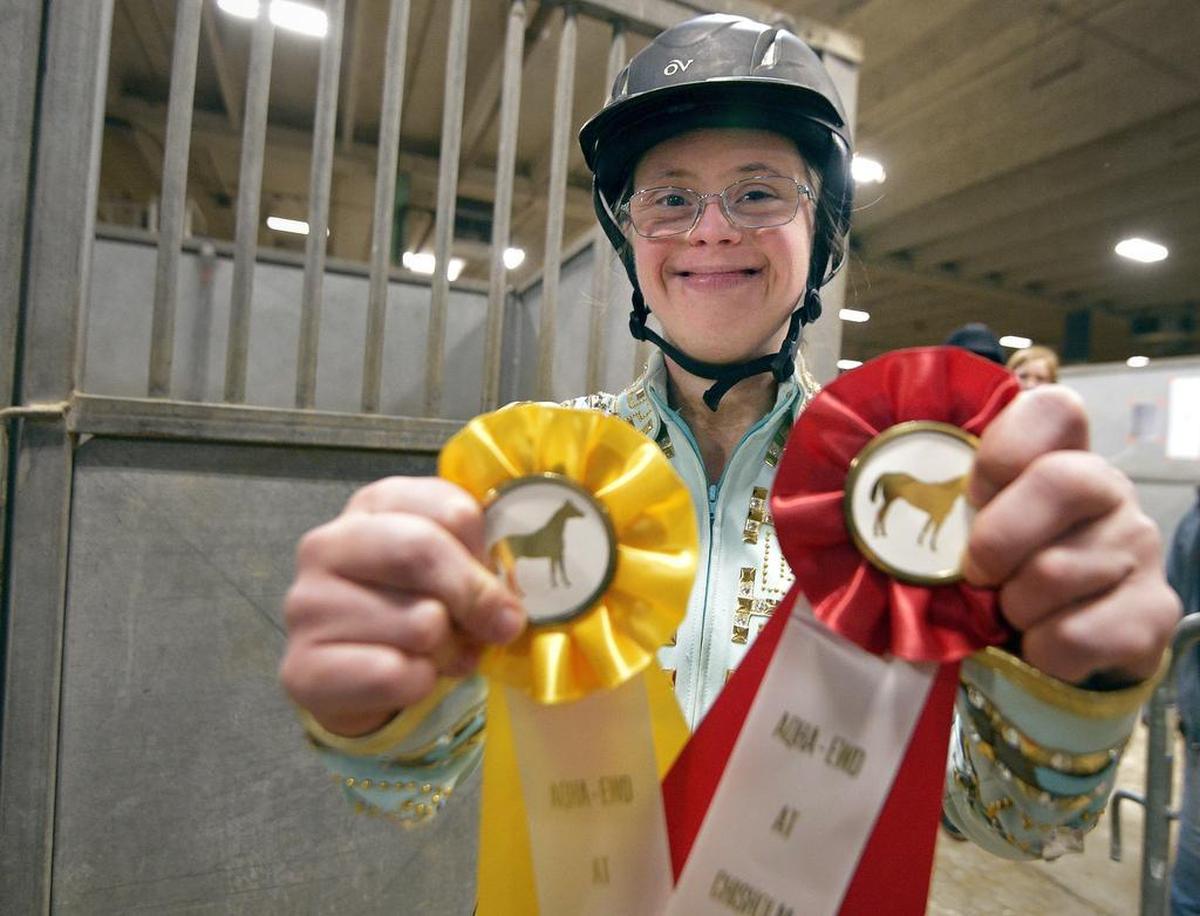 Sara “Happy” Waterman shows off the two ribbons that she won at the annual Chisholm Challenge on Monday. The riding event for people with special needs continues Tuesday and Wednesday at John Justin Arena at the Will Rogers complex in Fort Worth.