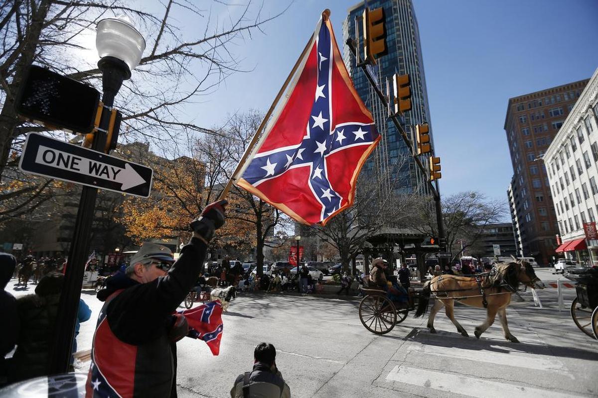 Dave, who would not provide his last name, displays the Confederate battle flag Saturday during the Fort Worth Stock Show and Rodeo All Western Parade in Fort Worth.