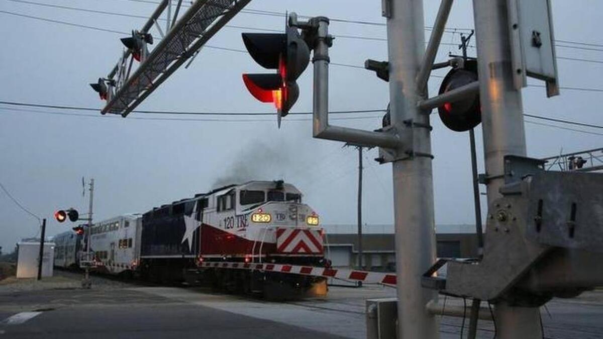 A Trinity Railway Express train collided with two disabled vehicles on a track in Irving Tuesday morning, but no injuries were reported.